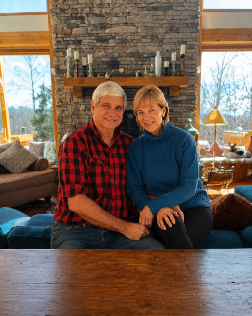 Owners of Bedford Landings Bed & Breakfast seated in the inn’s cozy living room near the stone fireplace at Smith Mountain Lake in Moneta, Virginia.