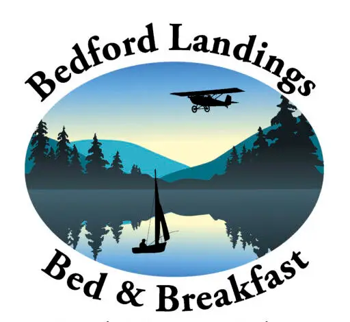 Circular logo showing a lake scene with a boat on calm water, silhouettes of trees, and a small airplane in the sky, encircled by the text 'Bedford & Breakfast' and 'Smith Mountain Lake, Virginia'